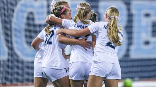 Maine women's soccer celebrates a goal.