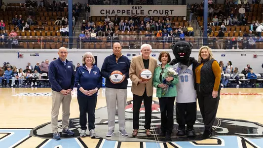 a group poses on Skip Chapelle Court