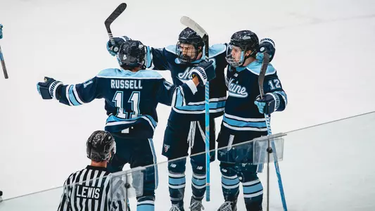 Maine men's hockey celebrates a goal.