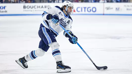 Harrison Scott shoots the puck.