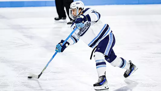 Jack Dalton shoots the puck into the zone.