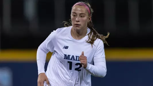 Abby Kraemer running on the field.