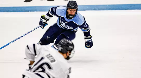Felix Trudea skates towards a UNH player.