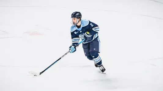 Jack Dalton skates the puck up the ice.
