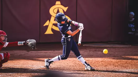 Softball player takes a swing.