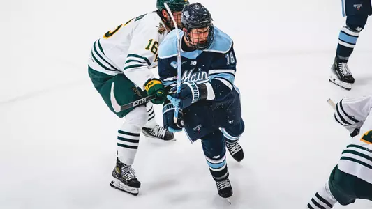 Parker Lindauer battles for the puck at Vermont.