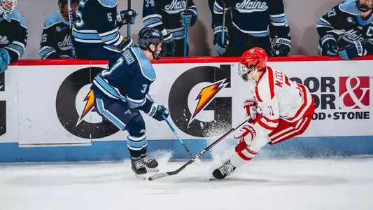 Luke Antonacci battles for a puck against BU.