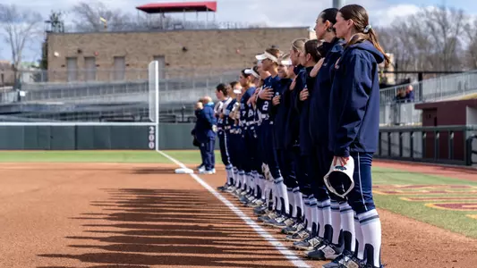 Softball stands on the foul line during introductions.