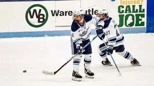 Josh Nadeau drops a puck for Lynden Breen.