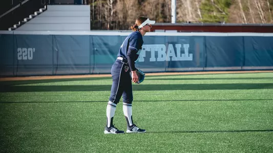 Maggie Helms stands in the outfield