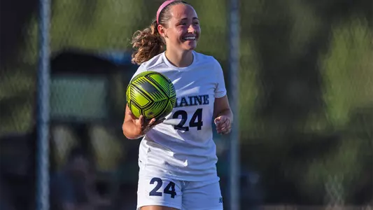 Grace Johnson throws the ball in.