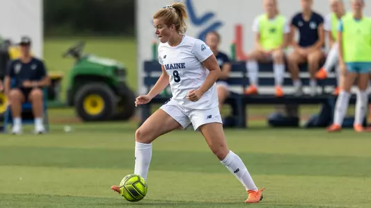 Lara Kirkby dribbles up the field.