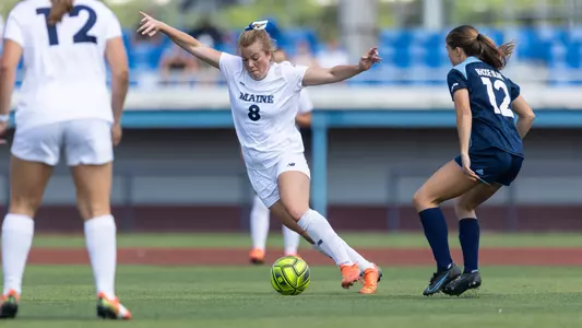 Lara Kirkby dribbles up the field.