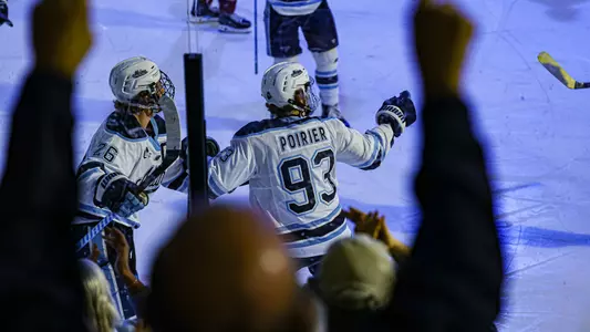 Maine men's hockey celebrates ag oal.
