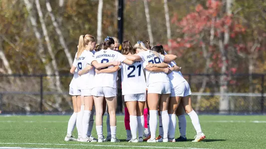 Maine women's soccer huddles as a team.