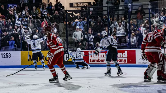 Maine men's hockey celebration photo.