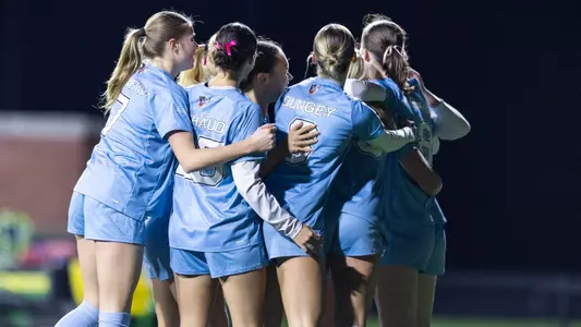 Maine women's soccer celebrates a goal.