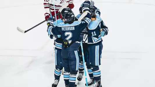 Maine men's hockey celebrates a goal.