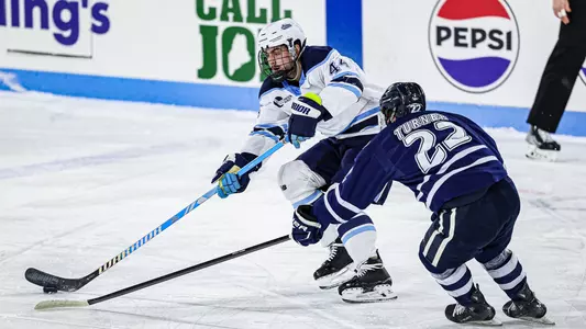 Frank Djurasevic battles for the puck.