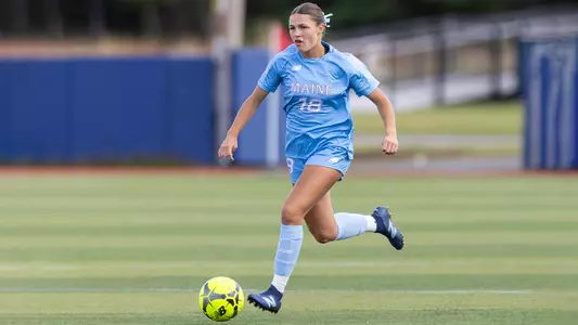 Myla Schneider runs up the field with the ball.