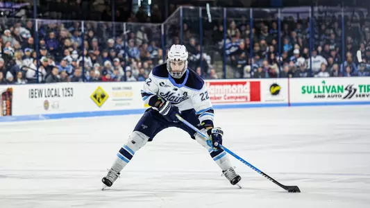 Harrison Scott carries the puck up the ice.
