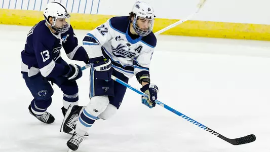 Harrison Scott carries the puck up the ice.
