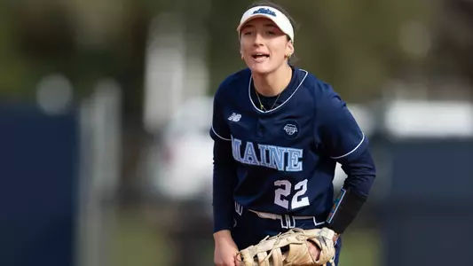 Madison Hand yells while in the field at first base for Maine.