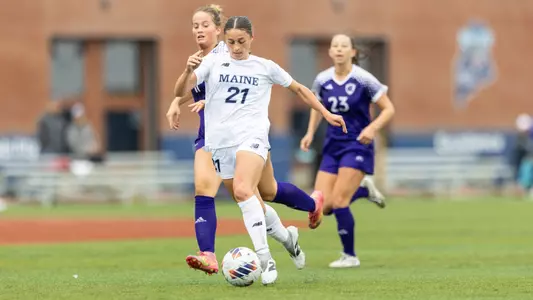 Jordane Pinette dribbles the ball up the field.