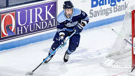 Charlie Russell carries the puck up the ice.