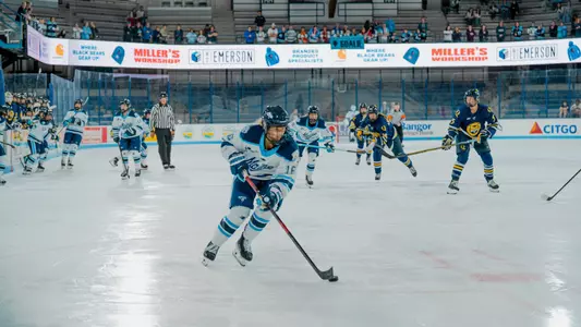 Raegan Wurm skates with puck