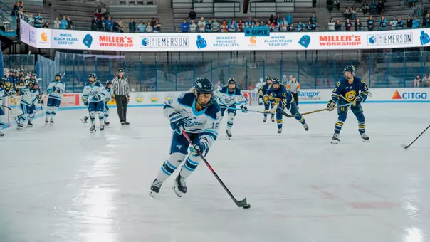 Raegan Wurm skates with puck