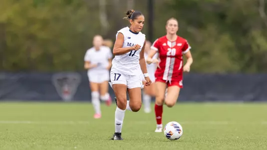 Isabella Meadows dribbles the ball up field.
