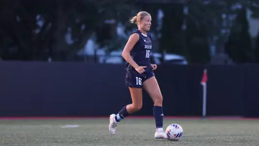 Olivia Grisdale dribbles the ball.