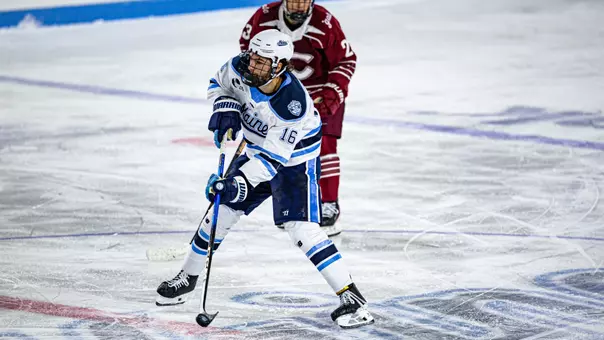 Loic Usereau with the puck in the neutral zone.