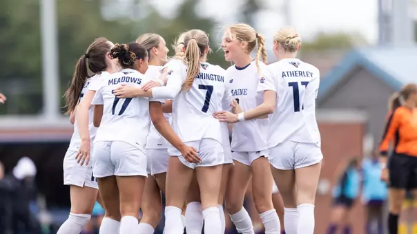 Maine women's soccer huddles.