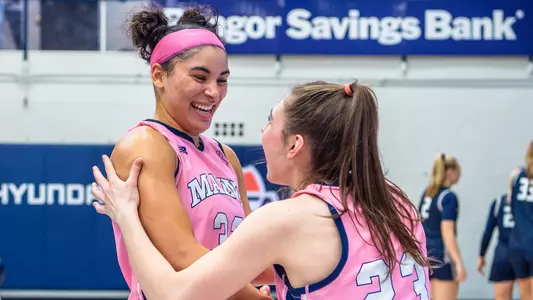 Adi Smith and Maddie Fitzpatrick celebrating in pink jerseys.