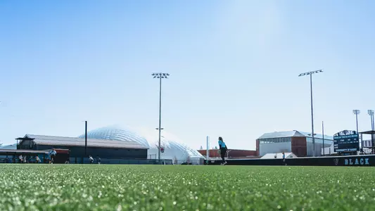 A wide shot during practice of the Maine softball field.