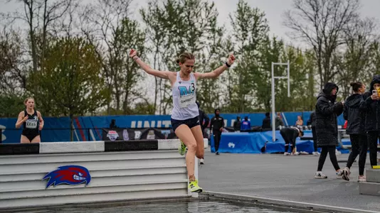 Lila Garbett jumps a hurdle.