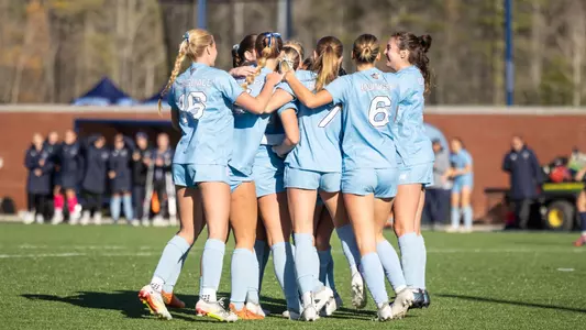 Maine women's soccer celebrates a goal.