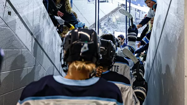 Maine women's hockey takes the ice through the tunnel.