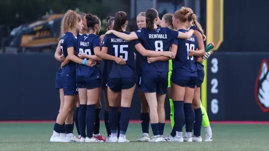 Maine women's soccer huddles.