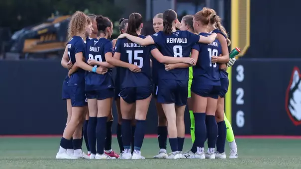 Maine women's soccer huddles.