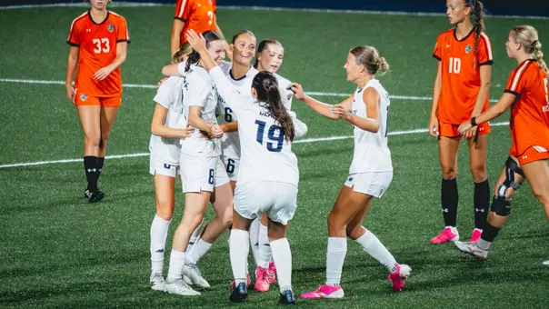 Maine women's soccer celebrates a goal.