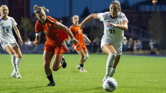 Juliane Belanger dribbles the ball up the field.