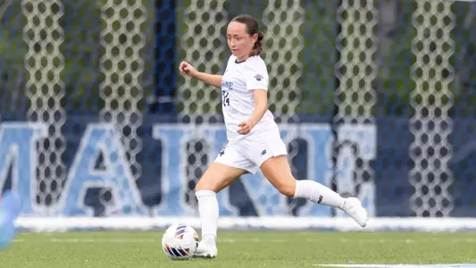 Grace Johnson kicks the ball up the field.