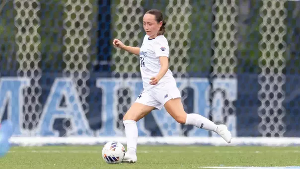 Grace Johnson kicks the ball up the field.