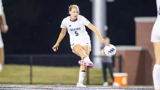 Lea Schroder kicks the ball up the field.