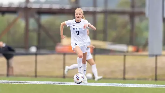 Abbey Thornton dribbles the ball up the field.