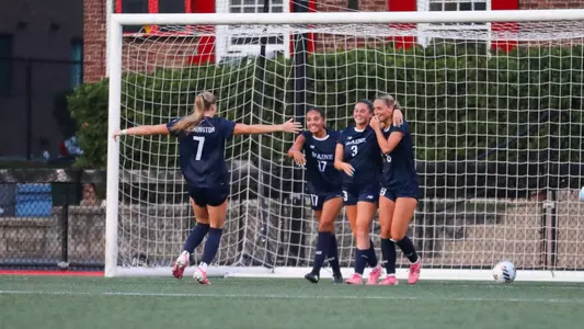 Maine women's soccer celebrates a goal.