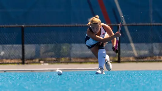 Plaehn strikes the ball with her stick.